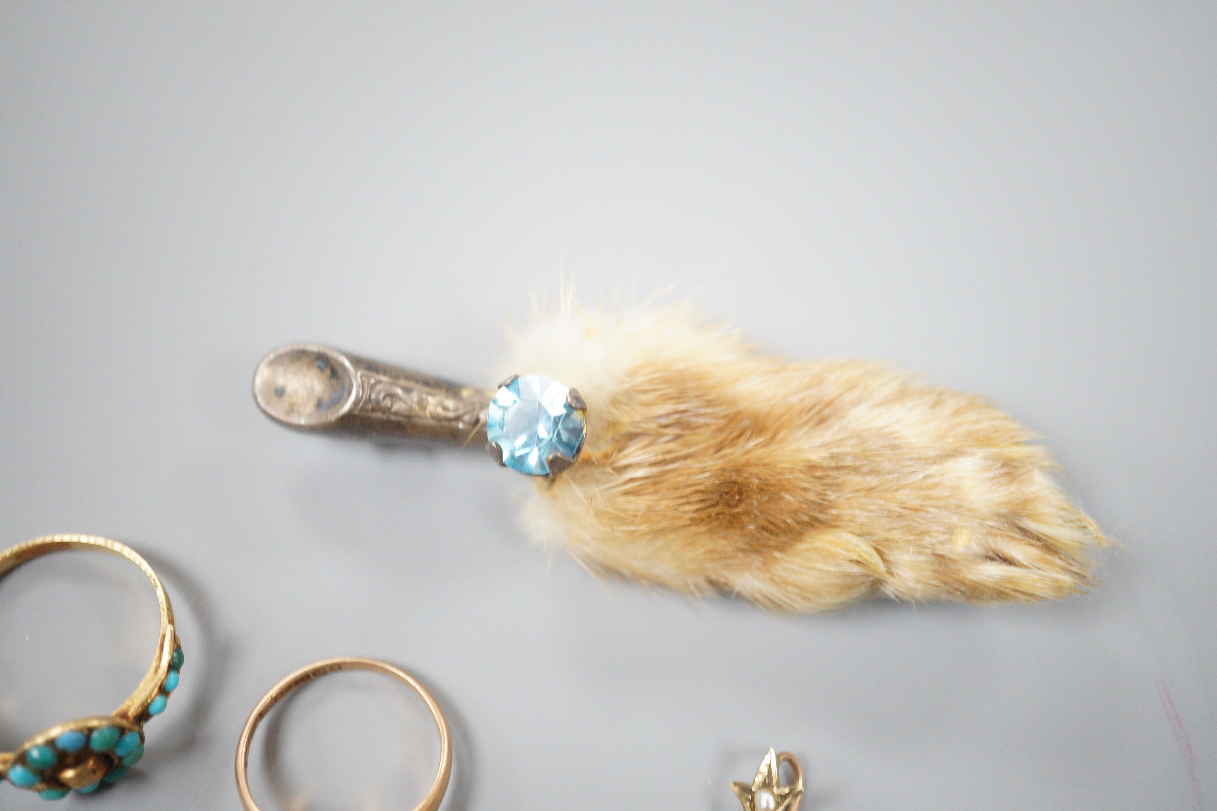 A small collection of jewellery to include an Edwardian amethyst and seed pearl pendant, two rings including Victorian yellow metal and turquoise 'buckle' ring, a bar brooch and a paw brooch.
